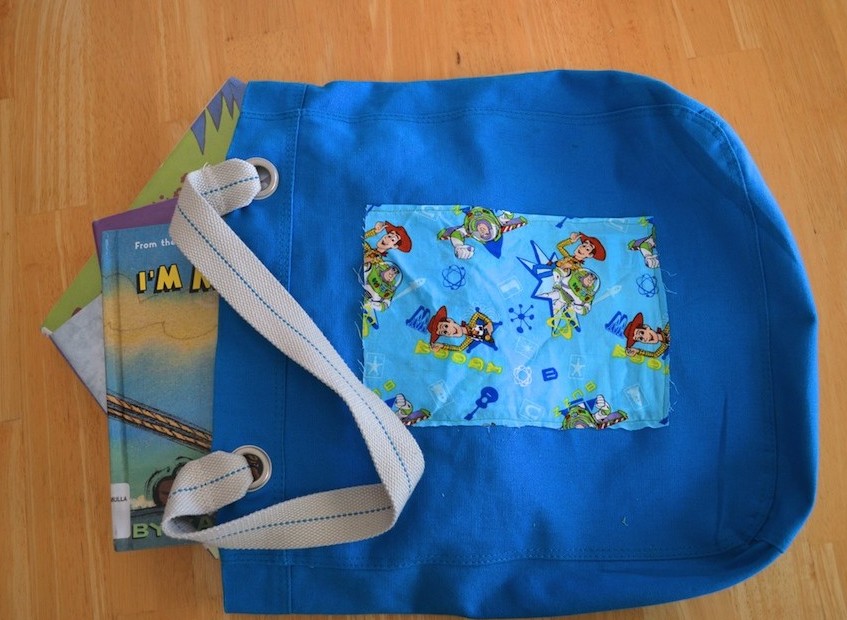 A promotional reusable tote becomes a fashionable library tote for kids. #upcycle #recycle #craft