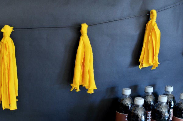 Simple tutorial for a DIY T-shirt Tassel Garland! Makes gorgeous and festive decor for home-gating parties, baby showers, birthday parties, or as an addition to your seasonal decor.